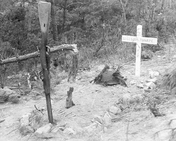 The grave of National Serviceman Private J Sharpe who was killed and buried where he fell on Middlesex Hill in Korea, 1950