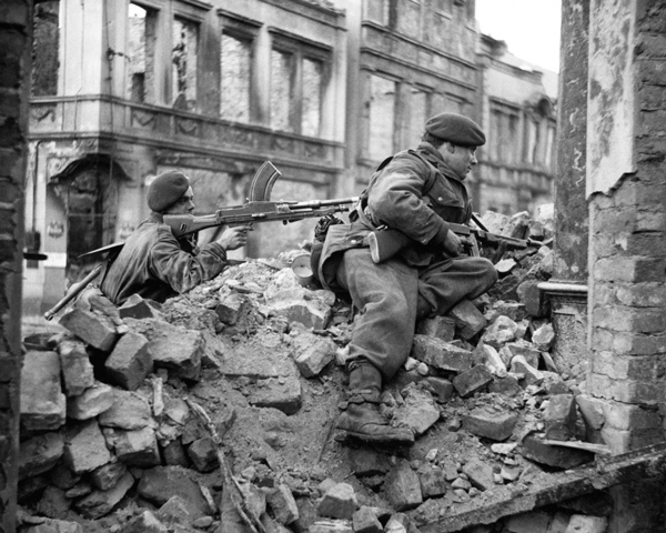 Members of No. 10 (Inter-Allied) Commando watch for snipers among the ruins of Osnabruck, 4 April 1945