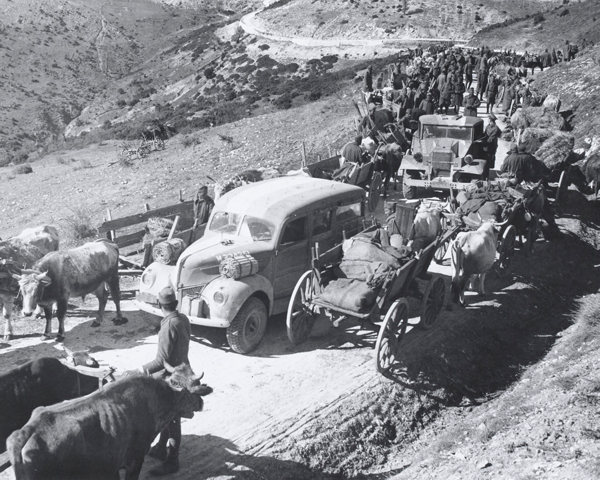 British vehicles pass through a Greek column, 1941