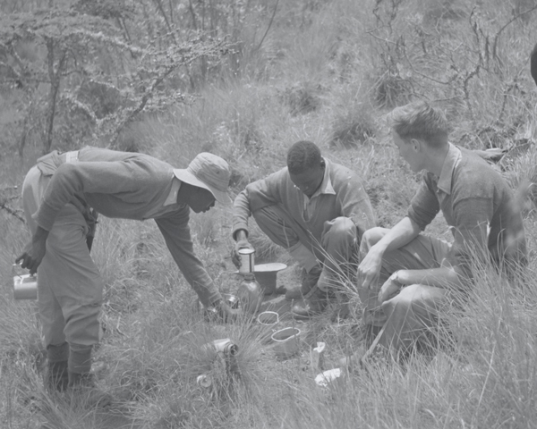 A British officer and men of the 4th King’s African Rifles brew up in the bush, 1950s