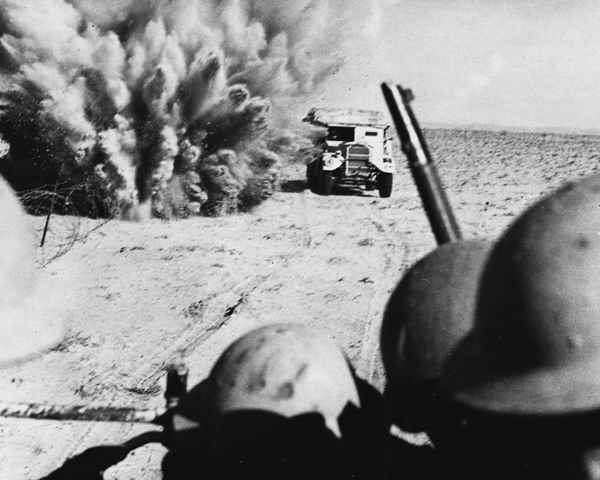  A mine explodes close to a British artillery tractor as it advances through minefields at El Alamein, 1942