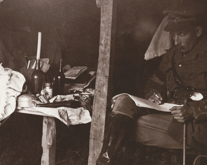 An officer relaxes in a dugout in the Ypres sector, c1917