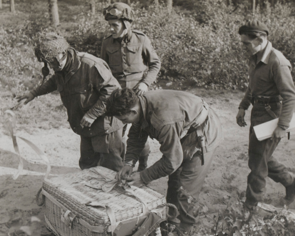 British airborne soldiers unwrap a parapack dropped on a resupply flight, 18 September 1944