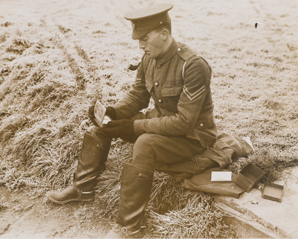 A soldier opening his Princess Mary Gift Tin, Christmas 1914