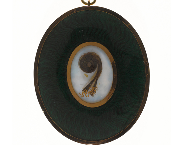 A lock of hair set into the back of a miniature by George Engleheart, c1800