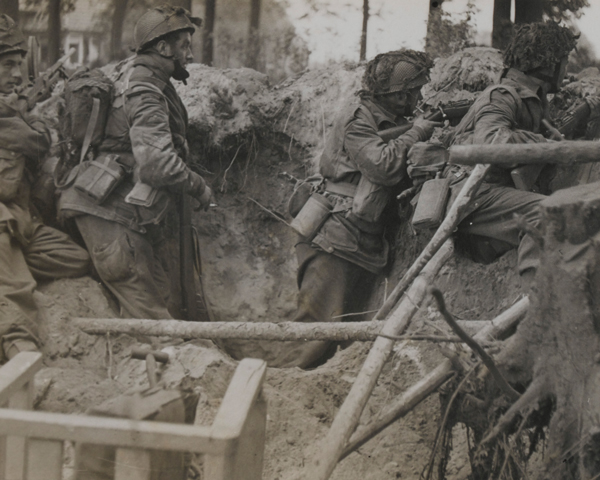 Paratroops of 1st Airborne Division take cover in a shell hole, Arnhem, 1944