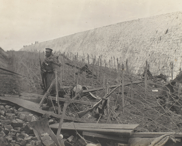Japanese sentry among barbed wire entanglements, Tsingtao, November 1914