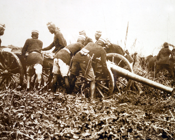 African soldiers moving a field gun into position, 1914