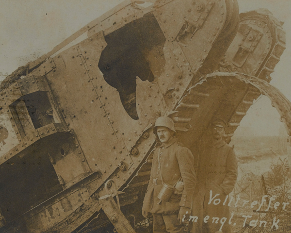 A German soldier next to a knocked-out British tank at Cambrai, 1917 