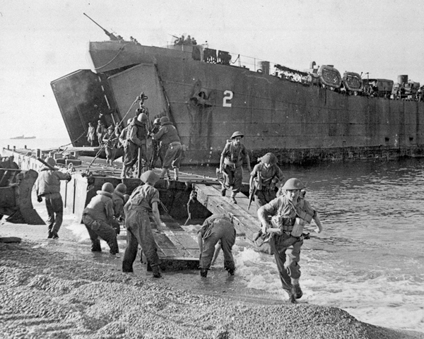 Disembarkation of men and equipment from a landing ship at Salerno, 1943