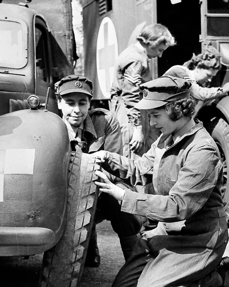 Princess Elizabeth changing the wheel of a vehicle, 1945