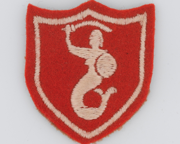 Sleeve badge worn by The Queen's Own Hussars, showing the crest of the city of Warsaw, c1958