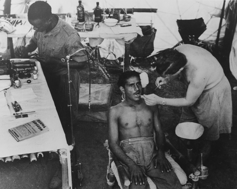 A dentist treats an Indian Army patient in Burma, c1944