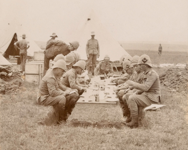 Officers of The Queen's Royal West Surrey Regiment eat lunch in the field, c1900