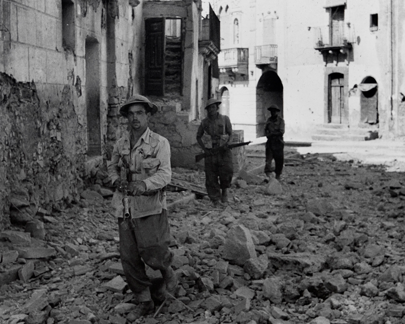Members of the 6th Queen's Own Royal West Kent Regiment on patrol in Adrano, Sicily, 1943
