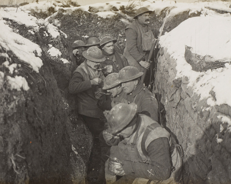 Soldiers from the 6th (Service) Battalion, The Queen's (Royal West Surrey Regiment), enjoy a hot meal in the trenches near Arras, 1917