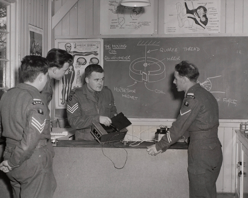 A RAEC sergeant instructs men from the Royal Electrical and Mechanical Engineers, c1955