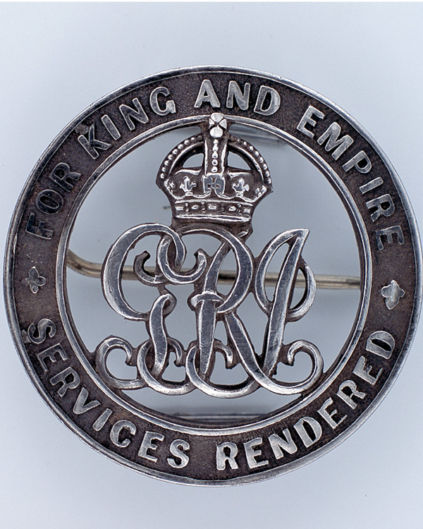 Discharge badge awarded to Private E Gibbs, 9th East Surrey Regiment, 1918