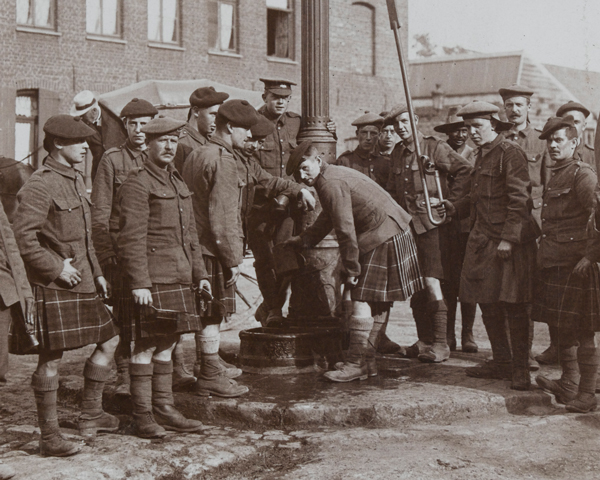 Seaforth Highlanders filling their water-bottles at a town pump, 1915