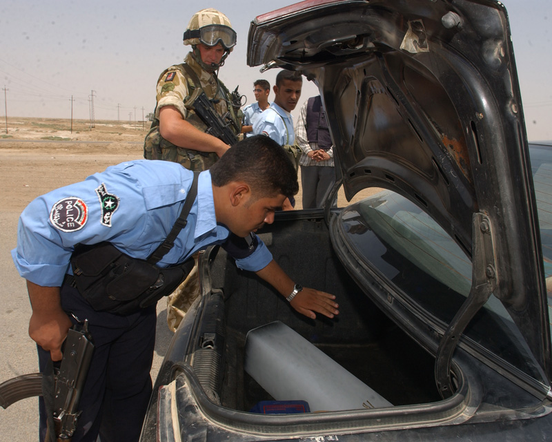 British soldiers and Iraqi police at a vehicle checkpoint, 2005