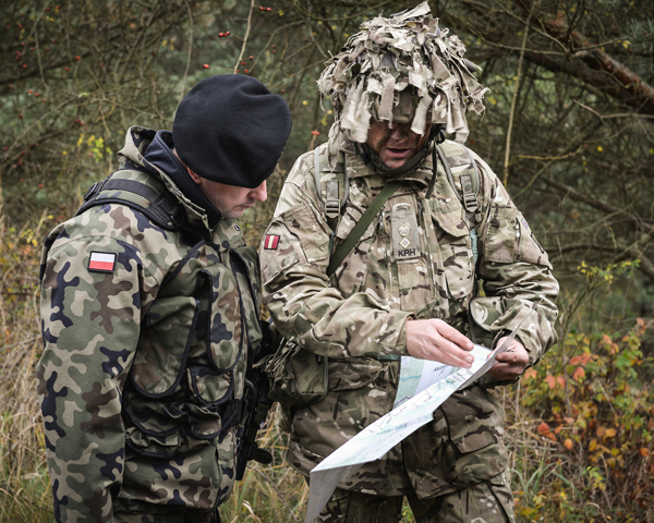 An officer of The King’s Royal Hussars confers with his Polish counter-part during ‘Exercise Black Eagle’, 2014