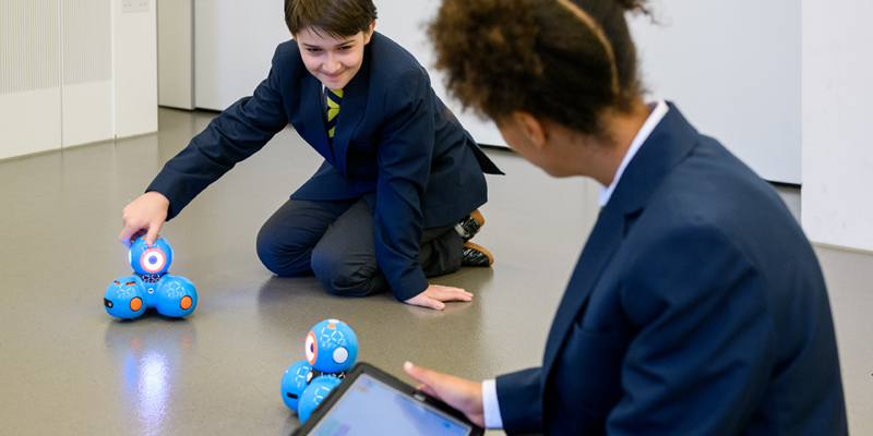 School children working with Dash robots