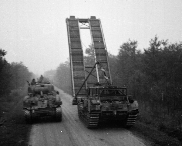 A Churchill AVRE bridge-layer passing a Sherman tank, 1944