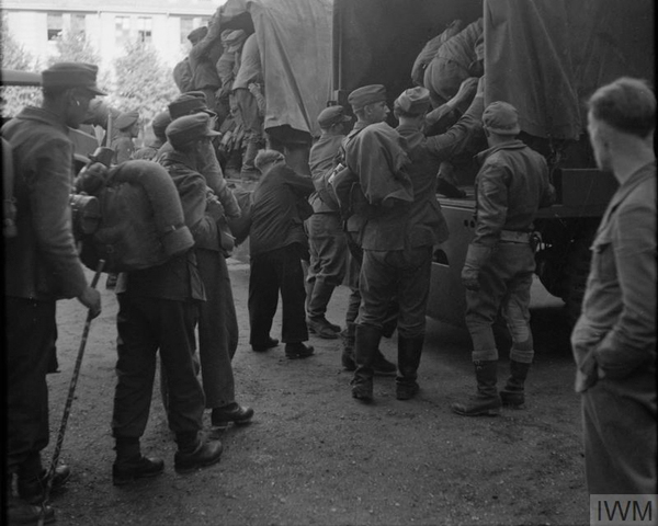 Demobbed German soldiers boarding lorries at Eutin barracks to be taken to various location to undertake reconstruction work, June 1945