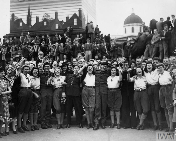 Members of the Women's Land Army celebrate with soldiers in Trafalgar Square on VE Day, 1945
