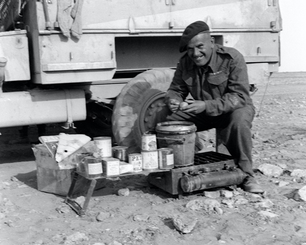 Sub-Conductor Mayland, Army Service Corps, preparing rations in the desert, 1942