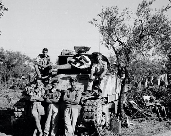 A Sherman tank crew pose with captured flag, 3rd/4th County of London Yeomanry (Sharpshooters), Italy, 1943