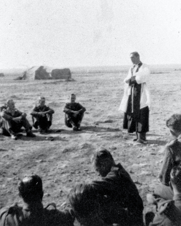 The Rt Reverend Hugh Rowlands Gough, Chaplain to 1st Battalion, The London Rifle Brigade, ministering to the soldiers in the desert, 1942