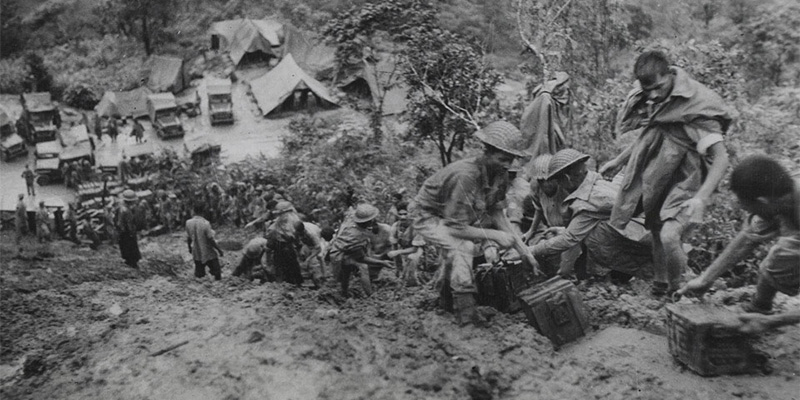 Indian troops moving ammunition down a slope, Burma, c1944