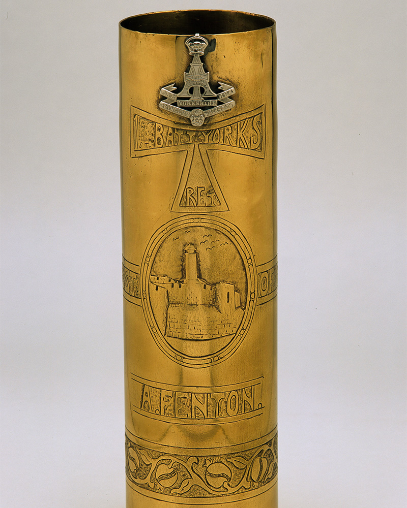 Shell case decorated with insignia of the Green Howards, c1918