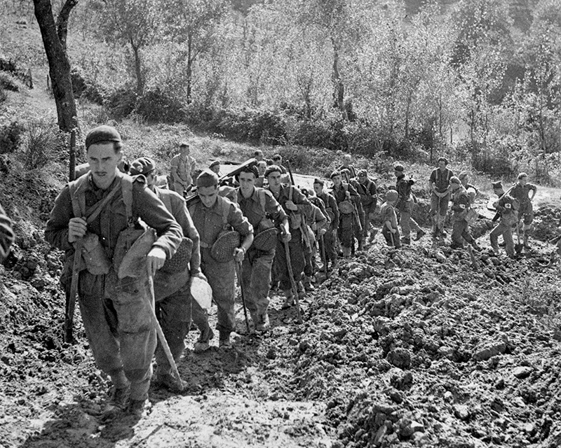 Grenadier Guards climbing a steep road to their forward positions, Italy, 1944