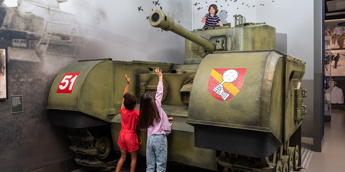Children playing on the replica tank in the Conflict in Europe gallery