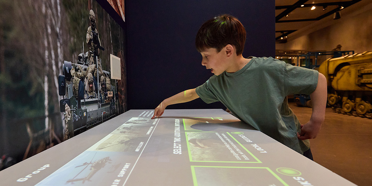 A child playing on the strategy table in the Conflict in Europe gallery