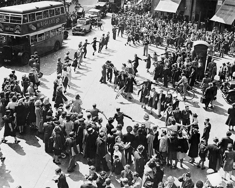 Crowds dancing in Oxford Circus, London, August 1945