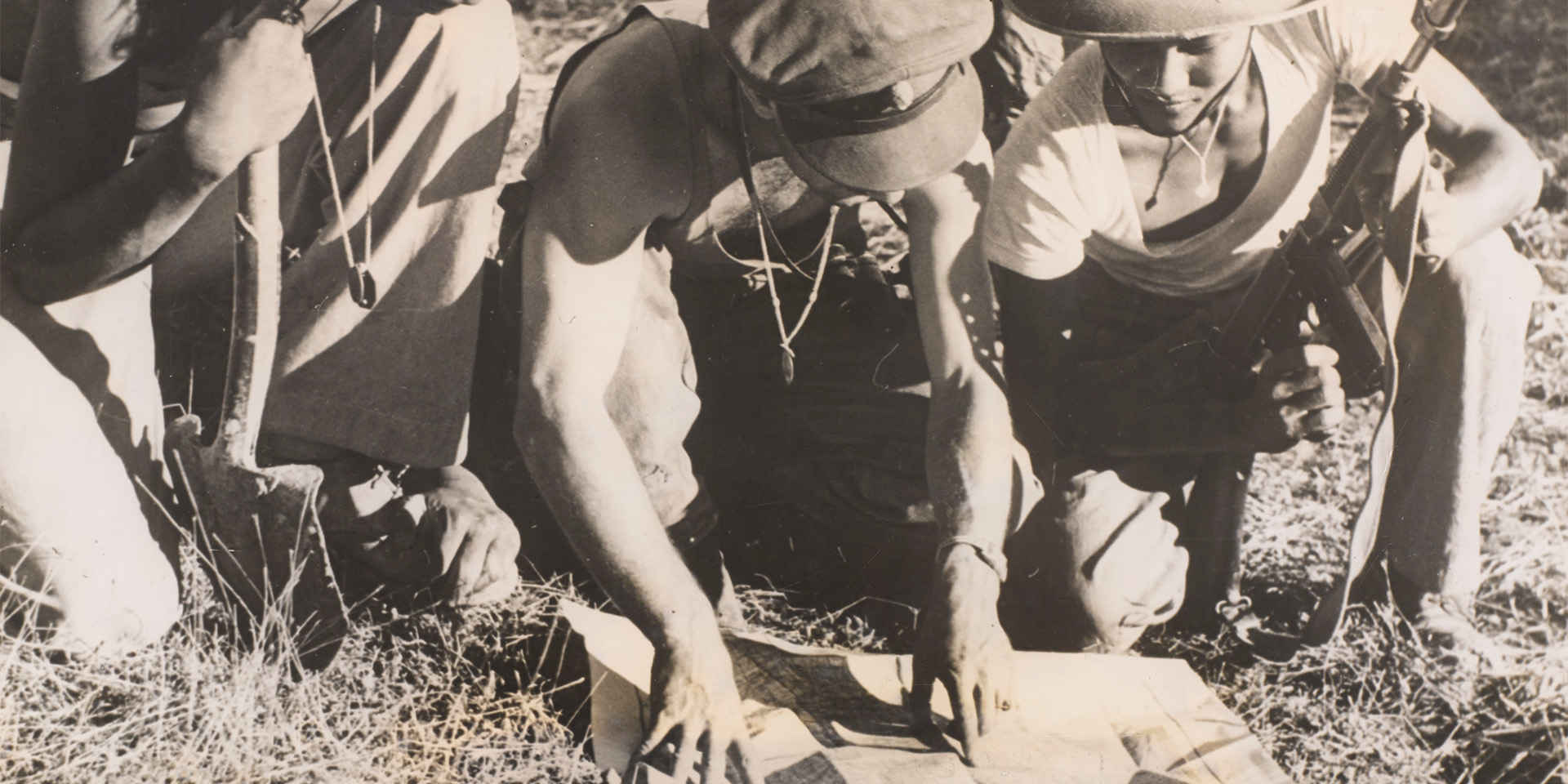 A British Commando officer confers with Burmese soldiers, Arakan, Burma, 1944