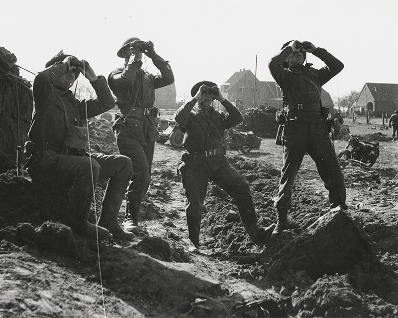 Soldiers with binoculars survey the skies, Germany, 1945
