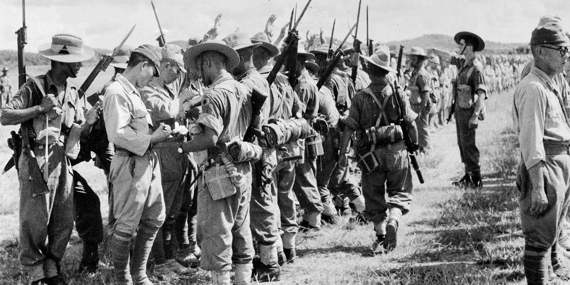 Soldiers of the 25th Indian Division searching Japanese troops after their surrender in Kuala Lumpur, Malaya, 1945