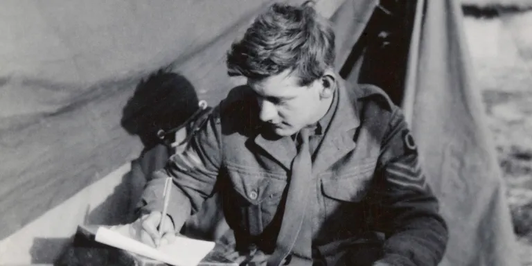 Sergeant Anthony Baker writing a letter during his service in Korea