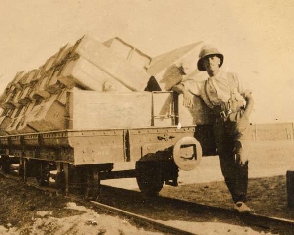 Joseph with a train truck of empty water tanks