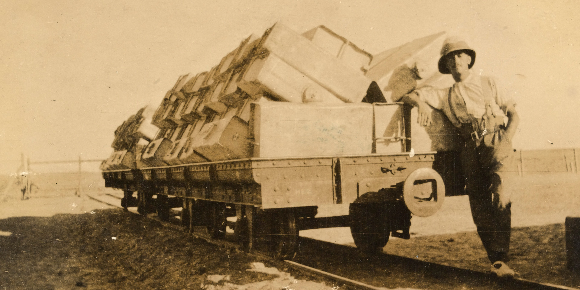 Corporal Joseph Egerton with a train truck of empty water tanks, Sinai, 1917