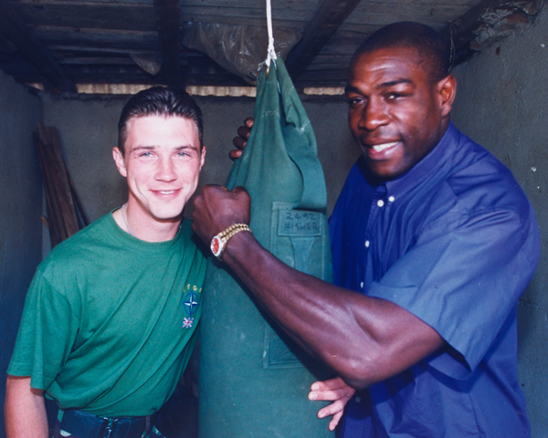 Frank Bruno meets Guardsman Patrick O'Keef, boxing champion of 1st Battalion The Irish Guards, Kosovo, 1999