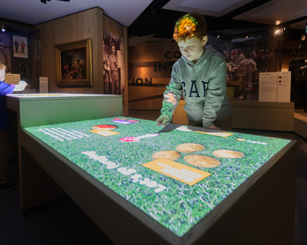 A visitor uses the interactive touch table