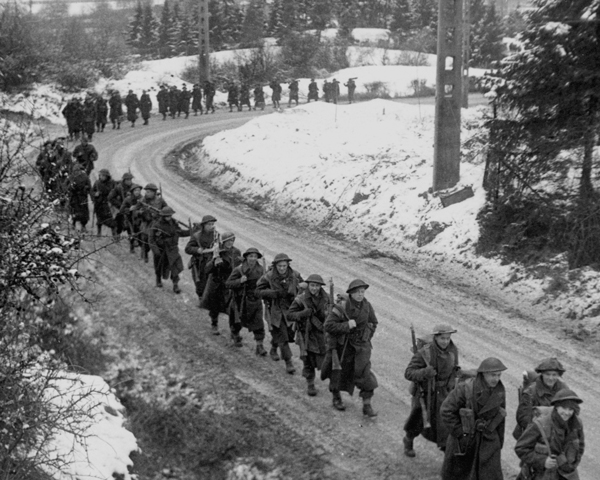 British infantry advance through the snow, Ardennes, December 1944