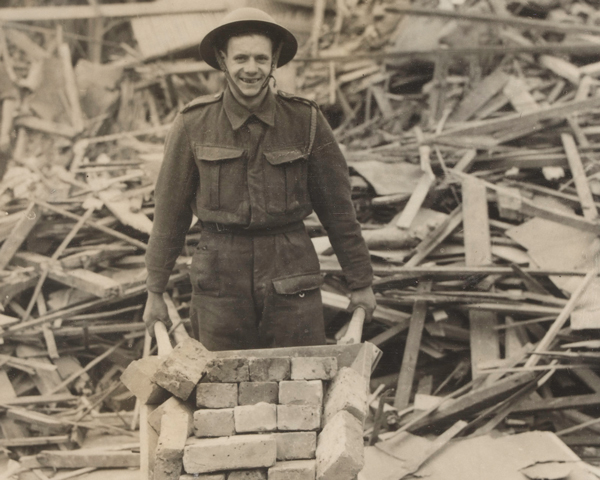 An Army Pioneer helps clear rubble, London, 1940