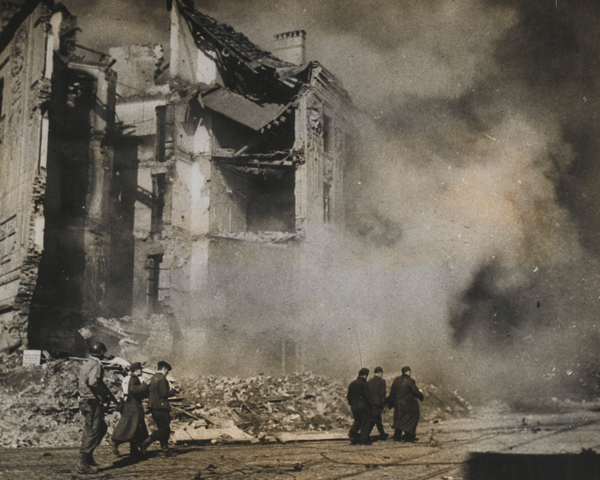 American troops escort prisoners through the shattered streets of Aachen, October 1944