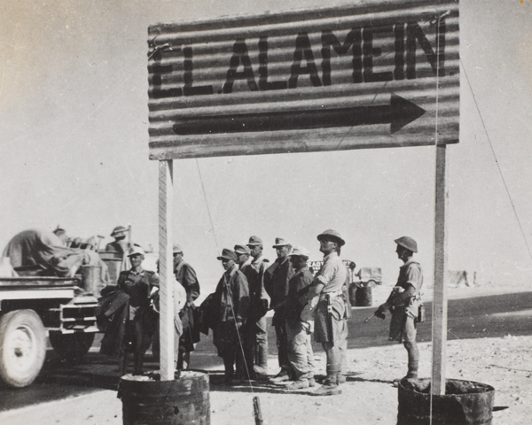 German prisoners of war under guard by a signpost to El Alamein, 1942 